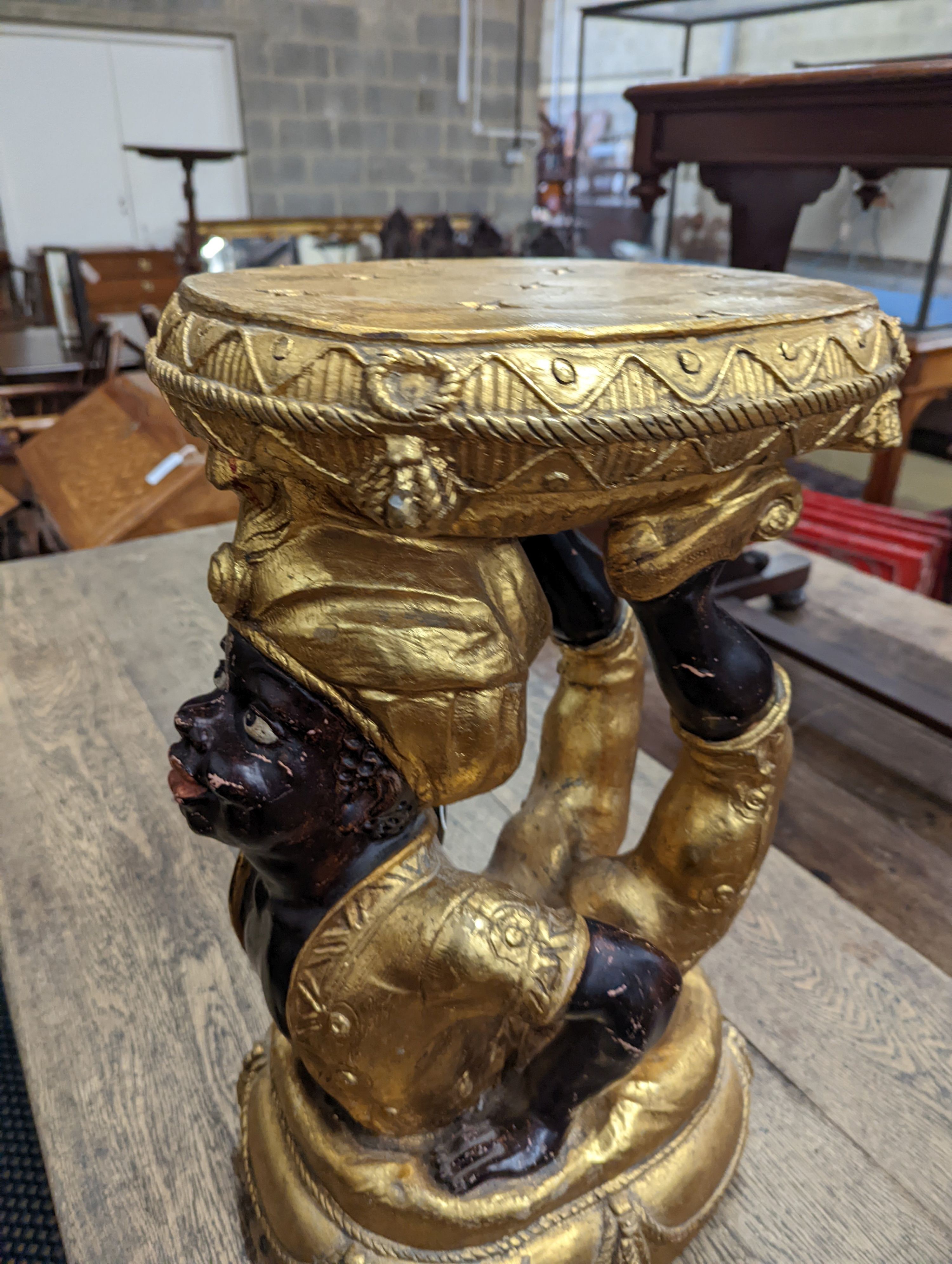 A Blackamoor stool. W-33cm, D-35cm, H-57cm.